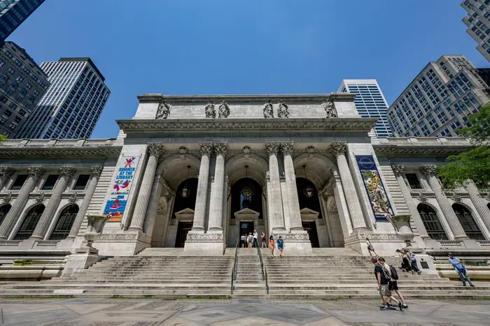 A view of the entrance to the New York Public Library in Midtown Manhattan in July. Library branches across the city might be subject to cuts under the city's Program the Eliminate the Gap.